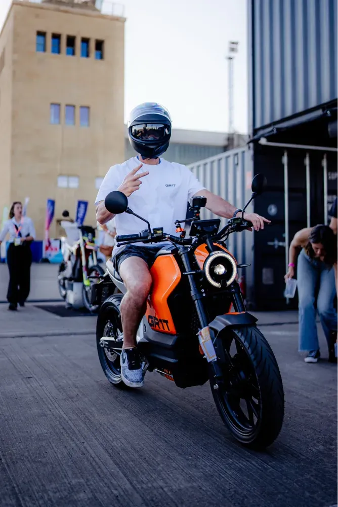 Rider on the orange GR1T G1S electric motorcycle at Reload.Land Berlin 2026