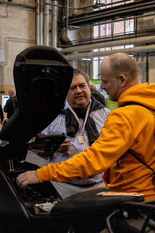 visitor-examining-gr1t-electric-motorcycle-storage-mc-messen-copenhagen-2026.jpg